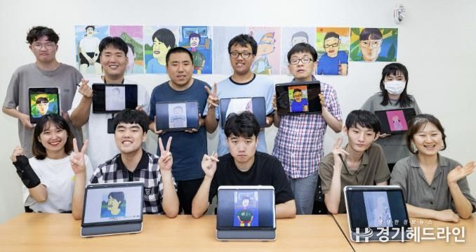 수원특례시 고향사랑기금 활용 사업으로 진행 중인 호매실장애인종합복지관 디지털 드로잉 작가 양성 교육 참여자 등 관계자들이 작품이 담긴 태블릿을 들고 기념촬영을 하고 있다.